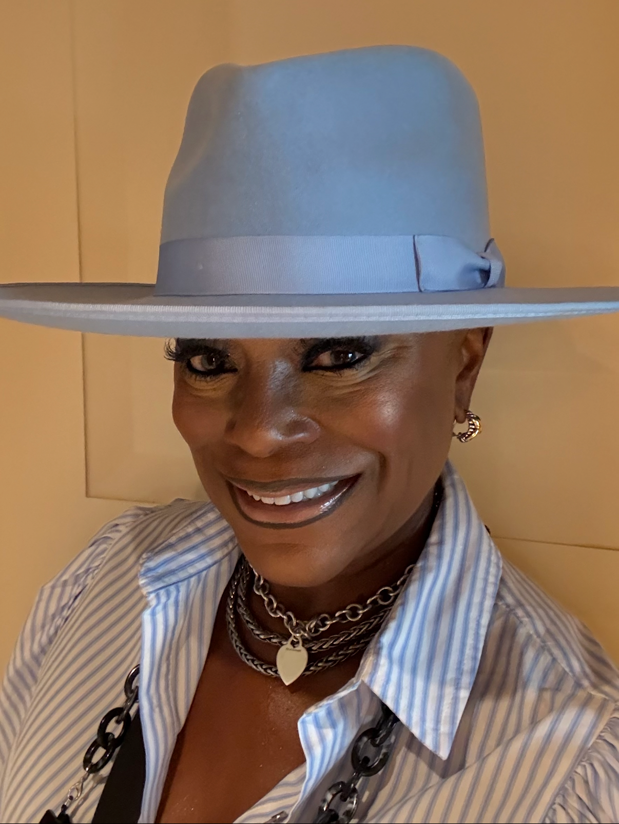 Sheila Bruce smiling in a blue hat
